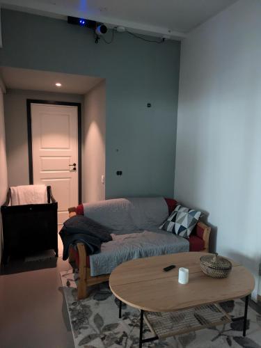 a living room with a couch and a table at Liten leilighet midt i sentrum in Stryn