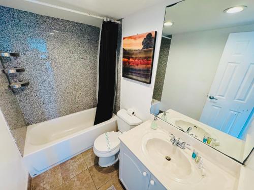 a bathroom with a sink and a toilet and a tub at Miami Hollywood High Rise Condo 004-22bvic in Hollywood