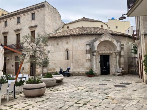 an old stone building with a courtyard in front of it at Hary Home in Brindisi