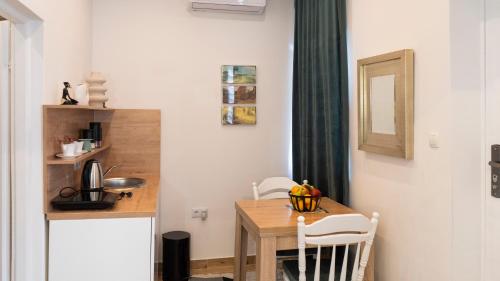 a small kitchen with a wooden table in a room at Guest House Time Out in Sarajevo