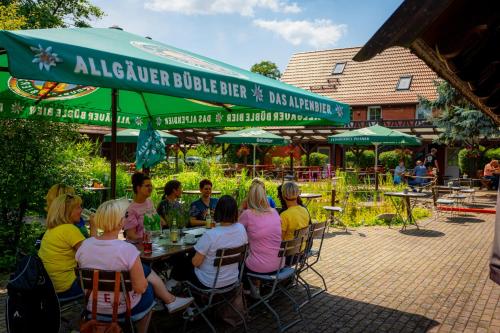 a group of people sitting at a table at Hotel Kolonieschänke in Burg