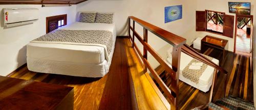 a bedroom with a bed and a stairway with at Pousada do Norte in Jericoacoara