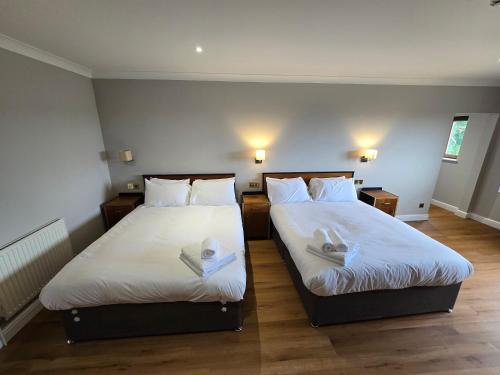 two beds sitting next to each other in a room at Staindrop Hotel in Sheffield
