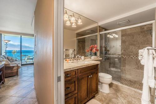 a bathroom with a shower and a sink and a toilet at KS507 Spectacular Oceanfront with Split AC Wailea in Wailea