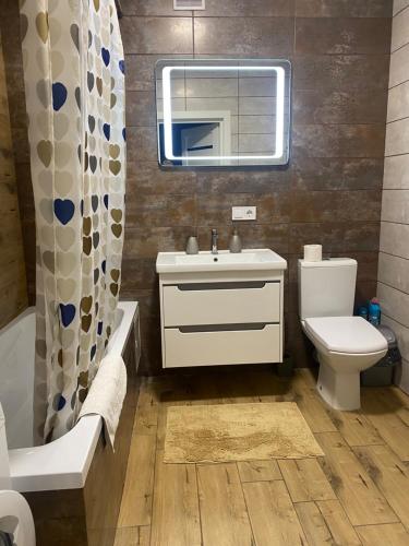 a bathroom with a sink and a toilet and a tub at Апартаменти Люкс, КОНДИЦІОНЕР, парковка, Авторинок, медцентр ЯНА - 5хв in Luts'k