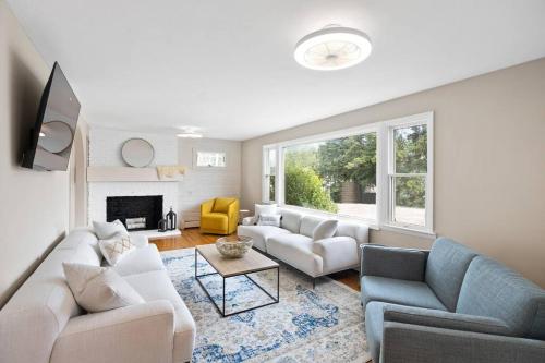 a living room with two couches and a fireplace at Nantasket Nest in Hull