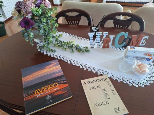 a table with a table cloth and a book at Ana Paula House in Aveiro