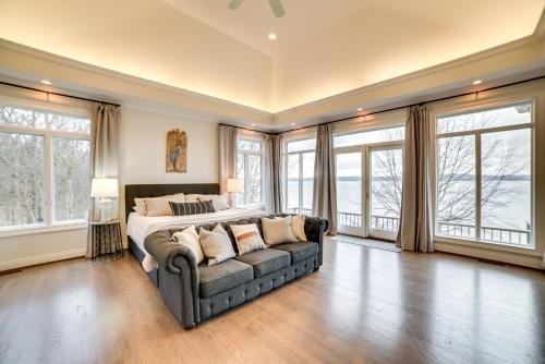 a large bedroom with a bed and a couch at Spacious Lakefront Kentucky Home Rental! in Cadiz