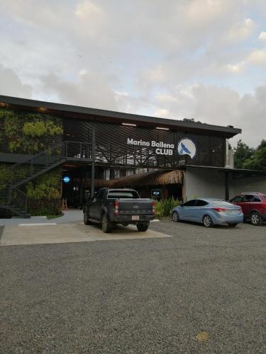 a building with a truck parked in front of it at Club Marino Ballena in Uvita