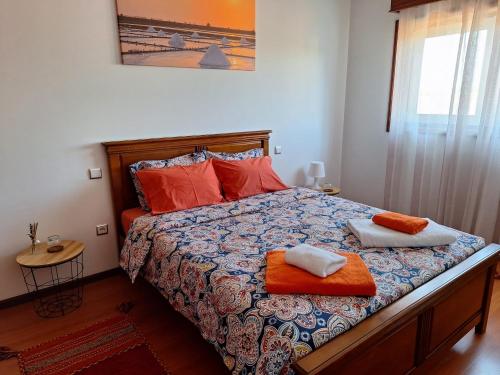 a bedroom with a bed with two towels on it at Ana Paula House in Aveiro