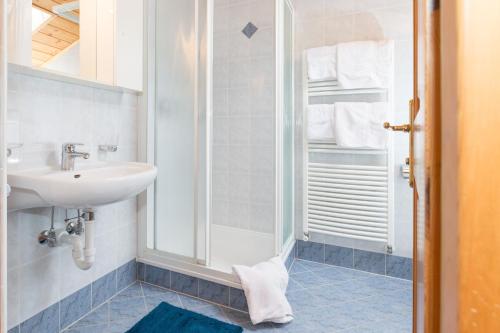 a bathroom with a sink and a shower at Obergostnerhof in Chiusa