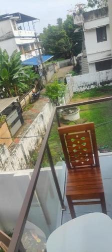 a chair sitting on top of a balcony at 88 homes Near Lulu Mall in Ernakulam