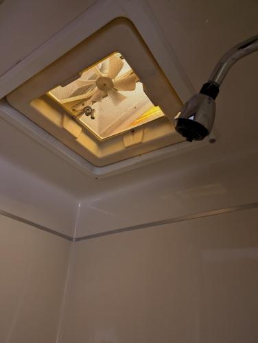a ceiling light with a fan on a ceiling at Stay RV Redcliff in Redcliff