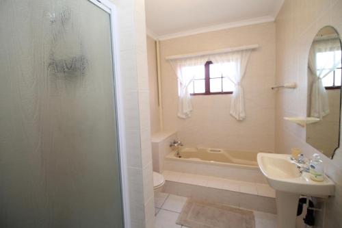 a bathroom with a shower and a sink and a toilet at Shelly De La Mer 5 in Shelly Beach