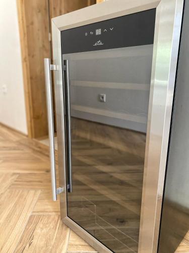 a microwave oven with its door open on a wooden floor at Treestudio Apartment in Lipí