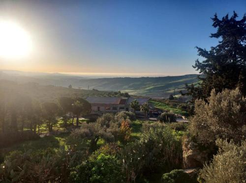 a view of the sun setting over a valley at Collina di Girgenti in Agrigento