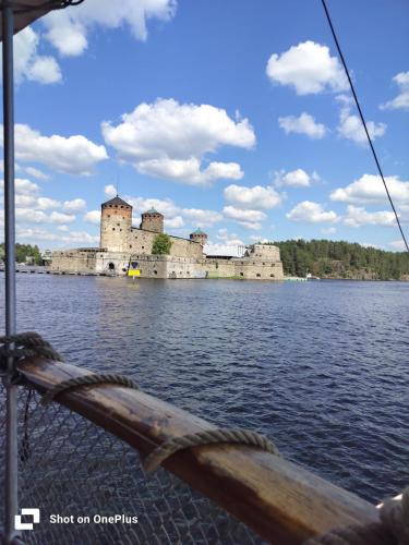 a view of a castle from a boat on a body of water at Retro House in Savonlinna