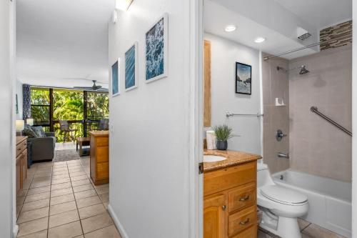 a bathroom with a toilet and a tub and a sink at MV3220 Modern Beautiful Tropical Gardenview in Kihei