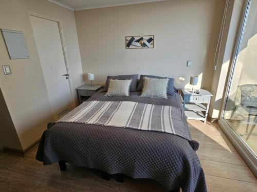 a bedroom with a large bed in a room at Departamento Centro Osorno in Osorno