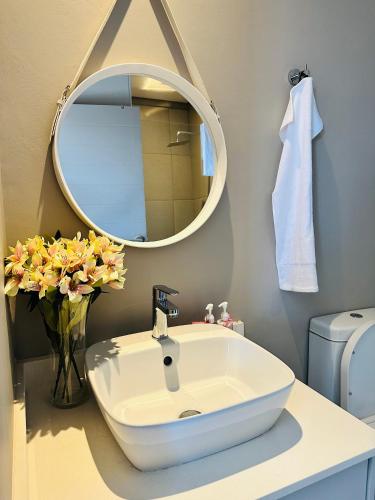a bathroom with a white sink and a mirror at Centurion Marnard Luxury Apt in Centurion