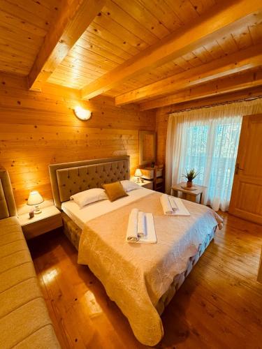 a bedroom with a large bed in a cabin at Apart Hotel Llolla in Ulcinj