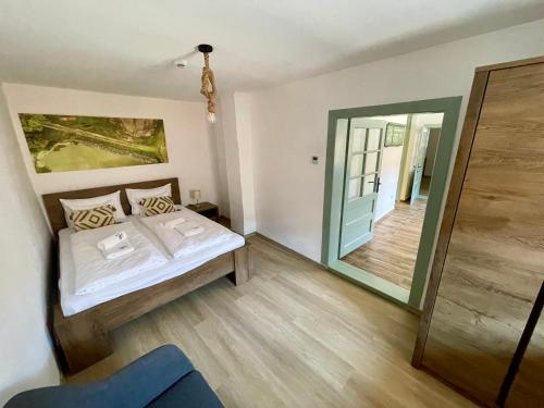 a bedroom with a bed and a large mirror at Majdnem 50 Vendégház - Villány in Villány