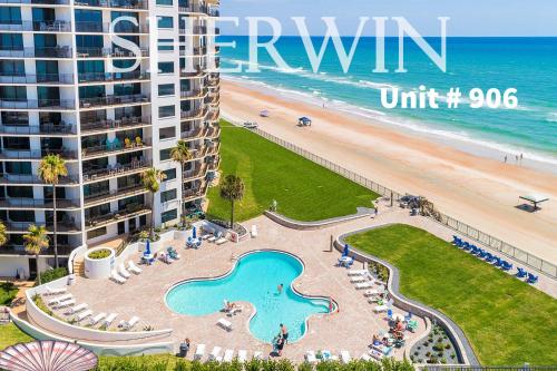 a view of the beach from the balcony of a resort at Vacation in Comfort and luxury - "THE SHERWIN" Oceanfront Condominium 906 in Daytona Beach Shores