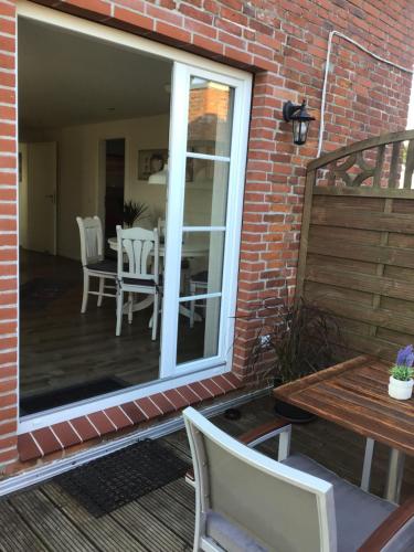 a patio with a table and chairs and a dining room at Ferienwohnung Adam in Wisch