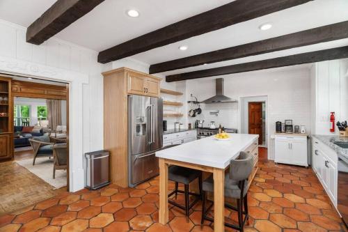 a kitchen with a table and some chairs in it at Luxe Retreat Designed For Group Getaways in Lodi
