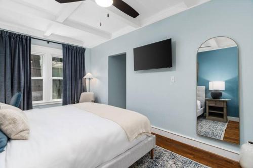 a bedroom with a large bed and a mirror at Luxe Retreat Designed For Group Getaways in Lodi