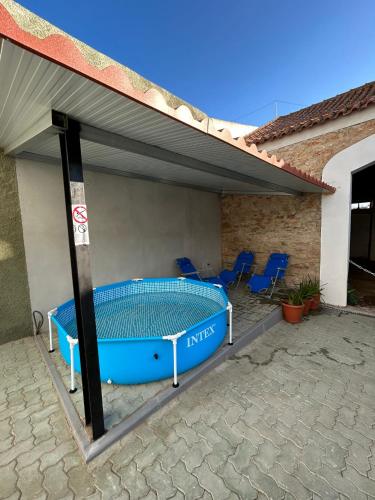 a patio with a swimming pool under a roof at Alojamento Cabeço de Vide in Cabeço de Vide