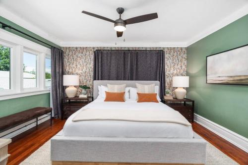 a bedroom with a large bed with a ceiling fan at Luxe Retreat Designed For Group Getaways in Lodi