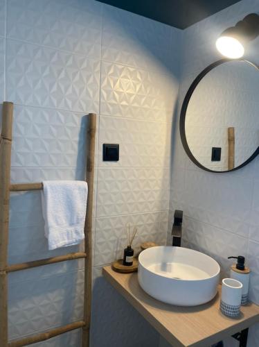 a bathroom with a white sink and a mirror at Mimosa House in Gythio