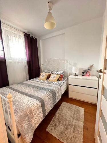 a small bedroom with a bed and a window at CENTRUM APARTMENTS MARSZALKOWSKa Parking in Warsaw