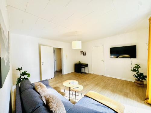 a living room with a couch and a table at aday - Solsortvej Suite 2 Randers in Randers