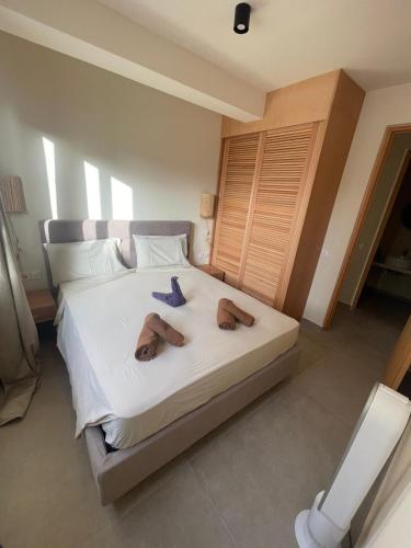 a bedroom with a bed with two slippers on it at Lagoon Apartment mit Pool Boa Vista in Sal Rei