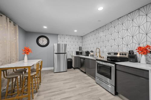 a kitchen with a table and a clock on the wall at Cozy Galleria Apt near Uptown with Free Park in Houston