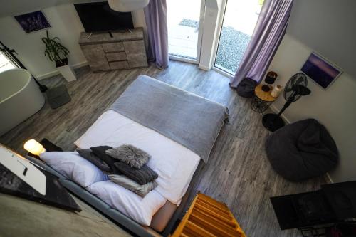 an overhead view of a bed in a living room at Bunkier House in Niedźwiada