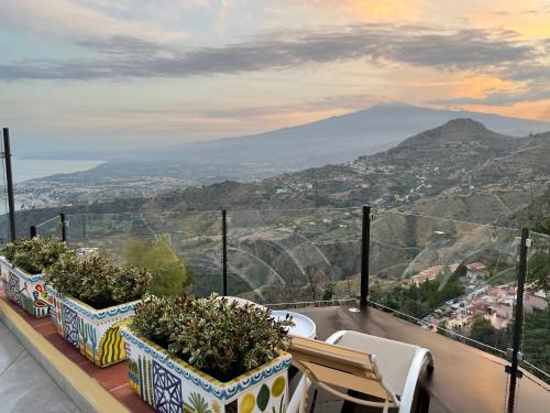 a balcony with plants and a view of a mountain at Villa Da Vinci Luxury Panoramic Apartments - Taormina rooms collection in Taormina