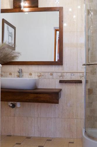 a bathroom with a sink and a mirror at Willa pod Lipami in Bartoszyce