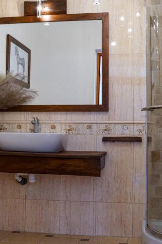 a bathroom with a sink and a mirror at Willa pod Lipami in Bartoszyce