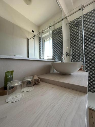 a bathroom with a sink and a large mirror at Riva Sweet Home in Giovinazzo