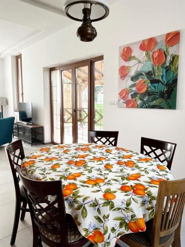 a dining room table with a flower pattern on it at Bela Vila in Banja Koviljača