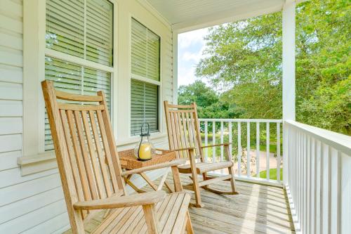 two rocking chairs sitting on the porch of a house at Less Than 6 Mi to Nags Head Manteo Beach House in Manteo
