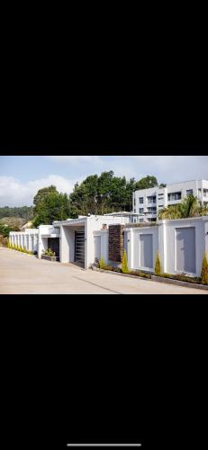 two pictures of a row of white buildings at Shobalenku Opulent apartments in Mbabane