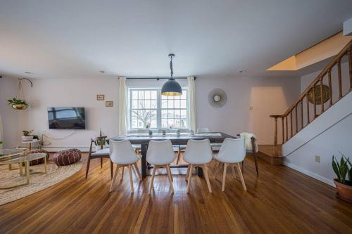 a dining room with a table and white chairs at 2Units 4BR 3BA Cape Cod Designer House in Atlantic City