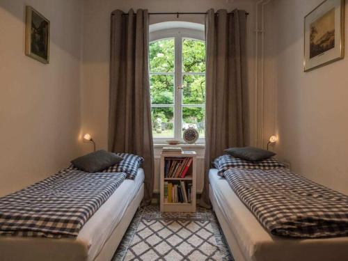 two beds in a room with a window at Holiday apartment Kutscherstube in Altenbeken