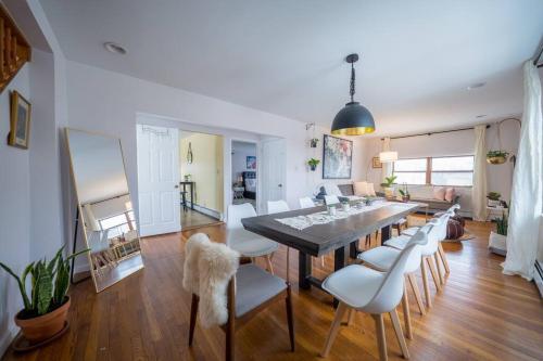 a dining room and living room with a table and chairs at 2Units 4BR 3BA Cape Cod Designer House in Atlantic City