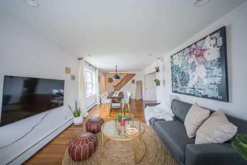 a living room with a couch and a large flat screen tv at 2Units 4BR 3BA Cape Cod Designer House in Atlantic City
