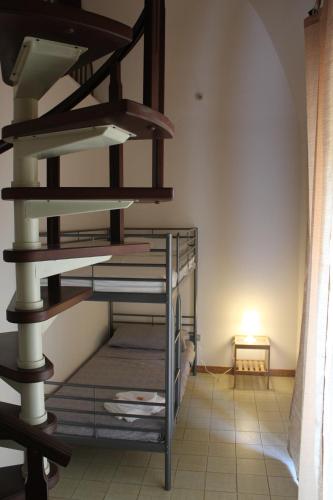 a spiral staircase in a room with a lamp at Casa P&G in Niscemi
